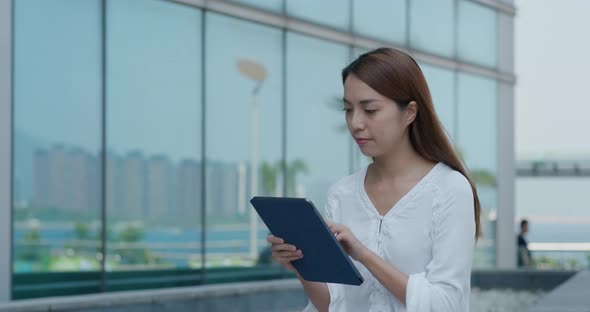 Woman look at digital tablet computer at outdoor