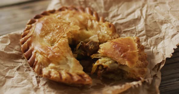 Video of pie seen from above on wooden background alt