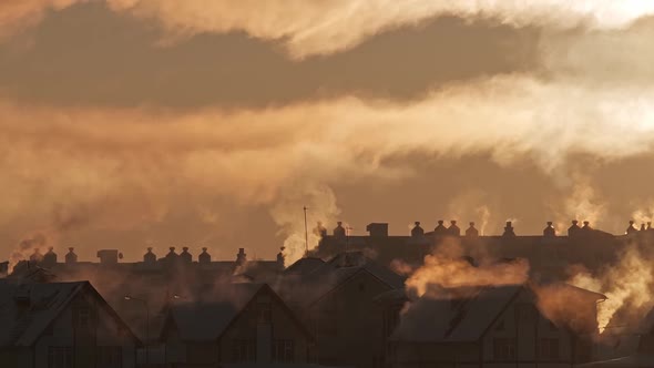 Chimneys on Roofs in the Light of Sunset