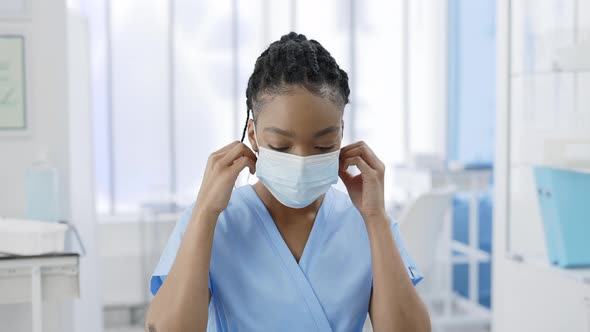 Portrait of Afro  American Female Nurse Taking Off Medical Protective Mask alt