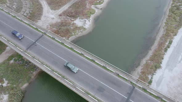 An Aerial Drone View of Cars Driving Over the Bridge.