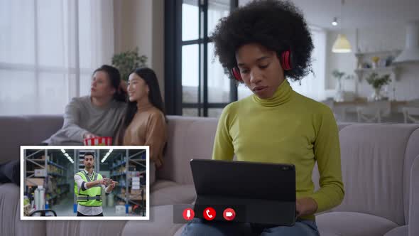 Video Chat POV of Concentrated African American Woman Looking at Tablet Screen As Middle Eastern Man alt