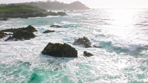 Aerial View  Drone Footage of Blue Ocean Waves Splashing Sea Cliffs on Beach alt