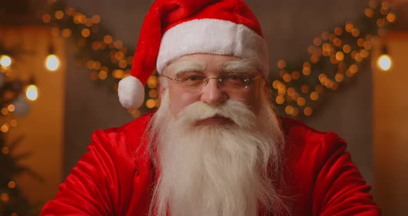 Kind Santa Claus in a Beautifully Decorated Living Room for the Holiday alt