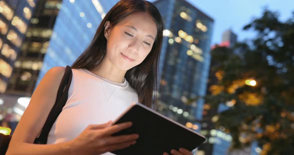 Business Woman Working on Digital Tablet in City at Night   alt