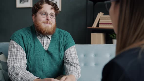 Joyful Man Talking and Gesturing Discussing Life Experience with Psychologist alt