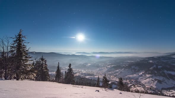 Fog Moving Over the Mountain in Winter with a Starshaped Sky alt