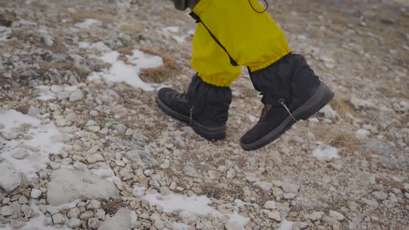 Male Tourist Is Walking in Mountains in Daytime, Close-up View of Feet Shod alt