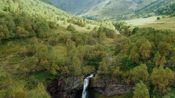 Aerial view; waterfall in autumn highland landscape