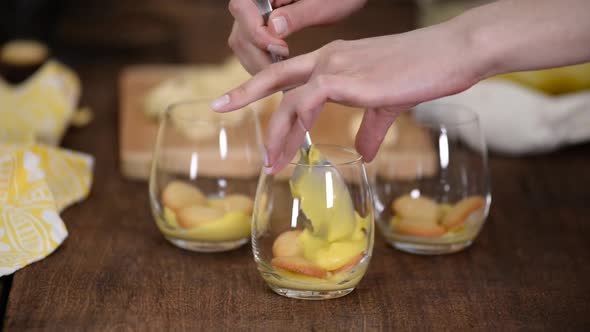 The Girl Making Banana Pudding in Glass Glasses in the Kitchen
