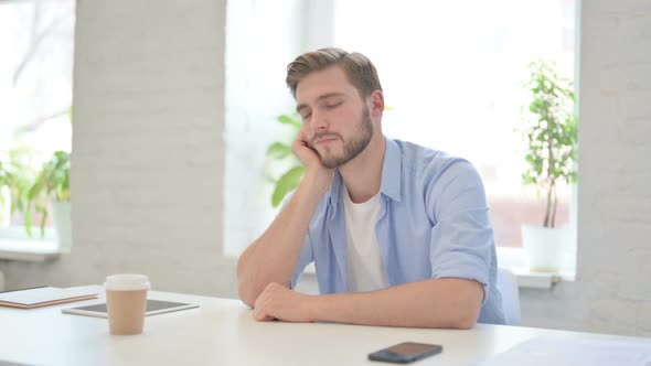 Young Creative Man Taking Nap in Modern Office alt