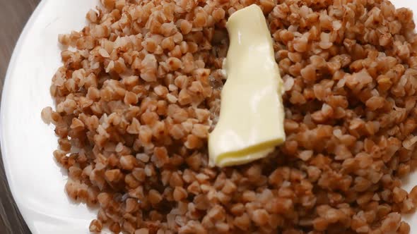 Buckwheat Breakfast Healthy Foot with Butter on a White Plate alt