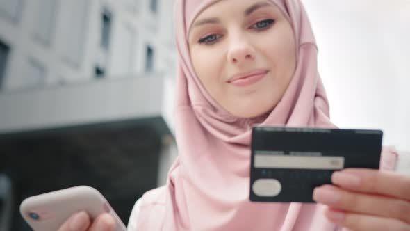 Muslim Woman Doing Shopping with Credit Card and Mobile alt
