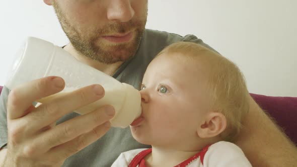Father feeding baby boy