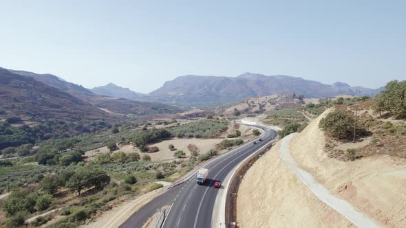 Cinematic road landscape. Epic view on the road in mountains, moving cars alt