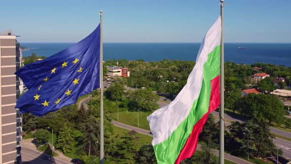 European Union and Bulgaria Flags Against City Varna at Summer Day alt