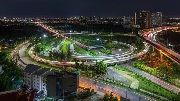 Highway interchange junction and traffic during rush hour in Bangkok outskirt, at night