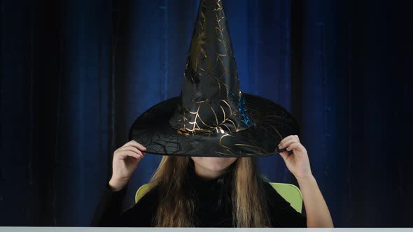 Child in black halloween hat
