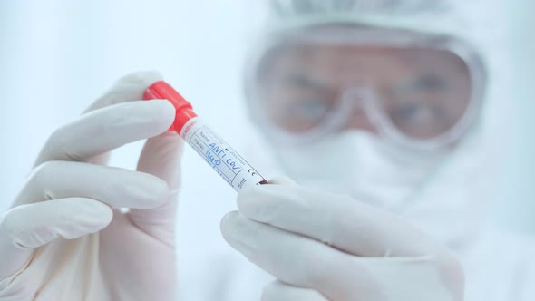 Doctor or Scientist checking sampling blood tube to make a medical diagnosis