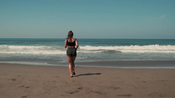 Jogger is Enjoying Jogging on Ocean Beach alt