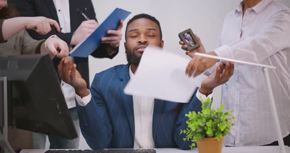 Calm Young Businessman Meditate at Business Meeting Avoiding Pressure of Annoying Angry Colleagues alt