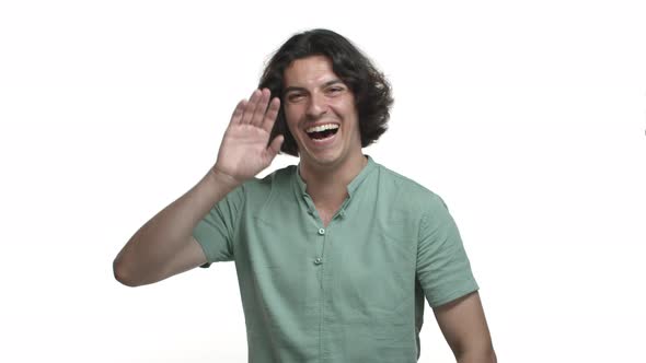 Handsome Hispanic Guy with Long Dark Hair Wearing Green Casual Shirt Laughing and Smiling Happy alt