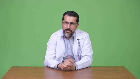 Handsome Persian Bearded Man Doctor Talking and Giving Consultation