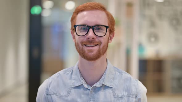 Portrait of Smiling Casual Redhead Man Looking at Camera  alt