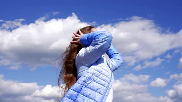 Happy Child in Autumn Jacket Enjoy Long Windy Hair on Sky Background Hairdo