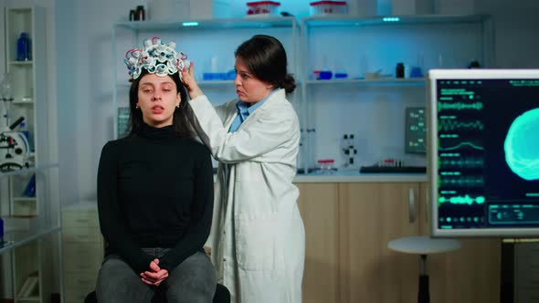 Medical Lab Technician Adjusting Eeg Headset Monitoring Brain Functions alt