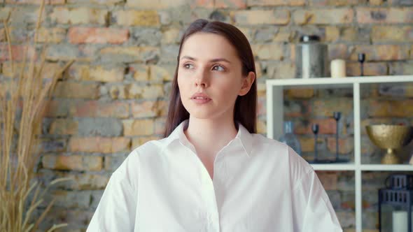 Young Attractive Businesswoman Sitting in Office and Thinking About Something alt