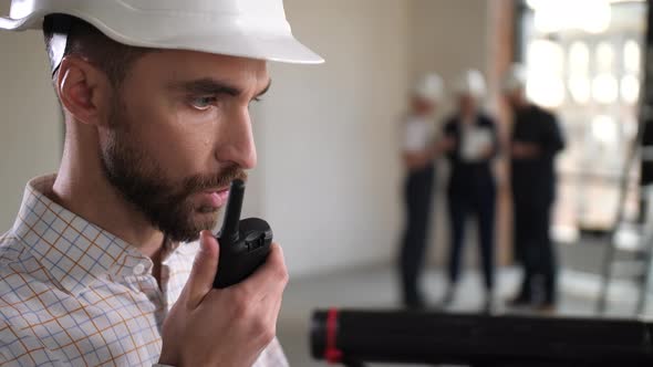 Portrait of Architect Talking Walkietalkie Indoor alt
