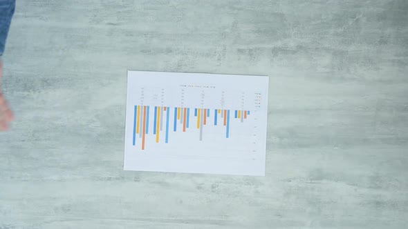 Hands Of Businessman Ripping Business Report. alt