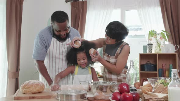 Joyful African American family cooking dinner together. Happy family