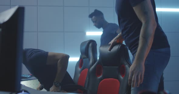 Gaming Team Sitting Down at Their Desks alt