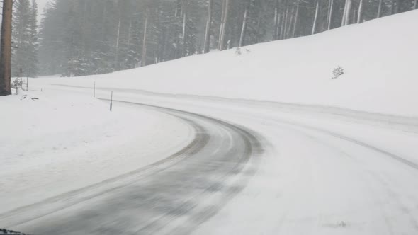 Mountain road during snowstorm