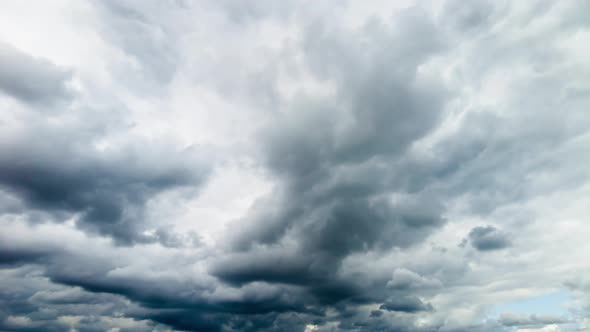 Storm clouds give way to white and blue skies, time lapse alt