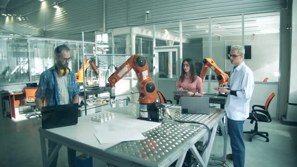 Group of Students, Young Engineers Testing Robot. Laboratory with Researchers Testing Robotic alt