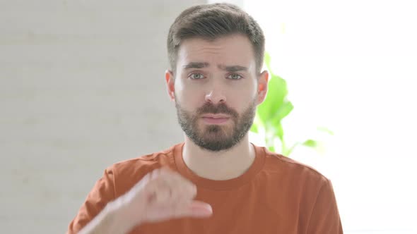Thumbs Down Gesture By Young Man alt