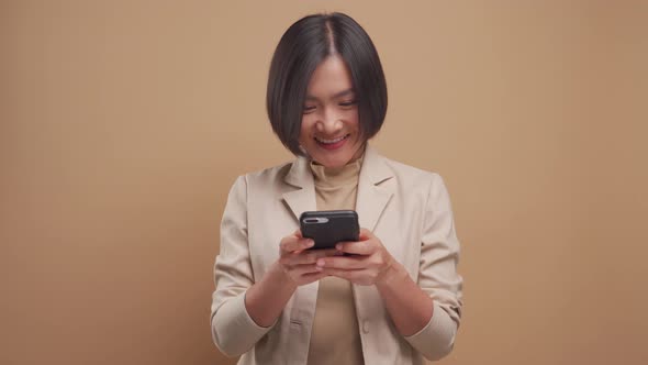 Happy asian business woman use smart phone for shopping online or contact friend on social media