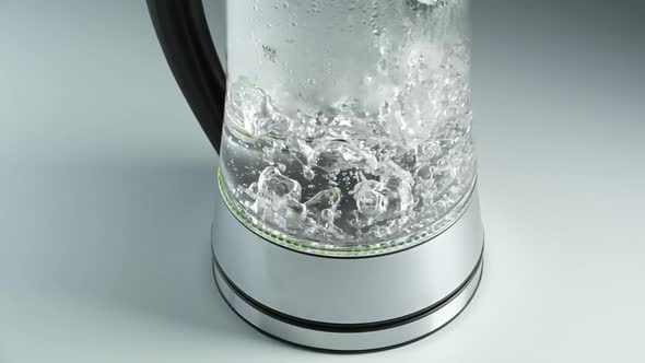 Water Boils in the Kettle on the White Table
