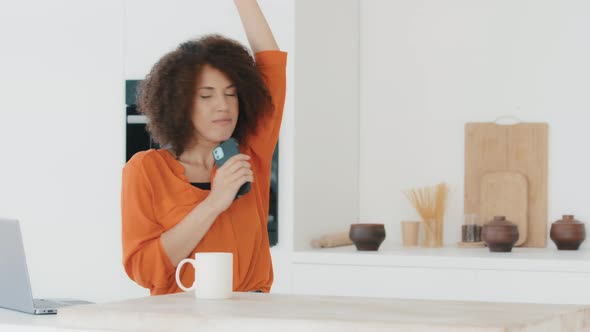 Active Cheerful Funny Girl in Orange Blouse with African Hairstyle with Curls Biracial Women alt