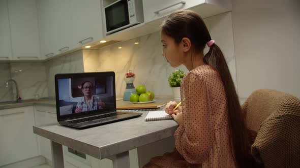 Lovely Preteen Schoolgirl Having Remote Classes with Tutor Online alt