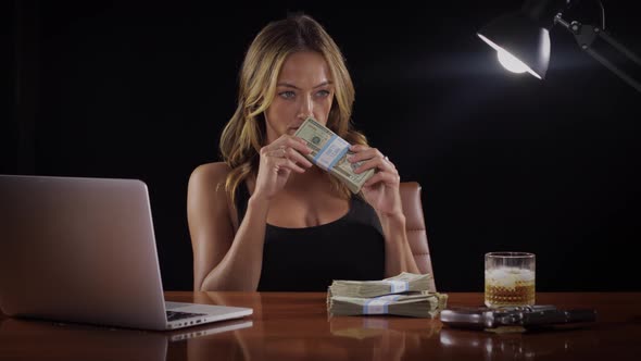 Sexy woman with a stack of money alt