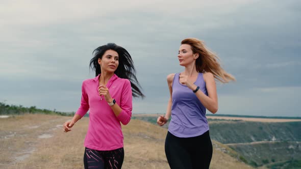 Two Woman Running the Run on the Field alt