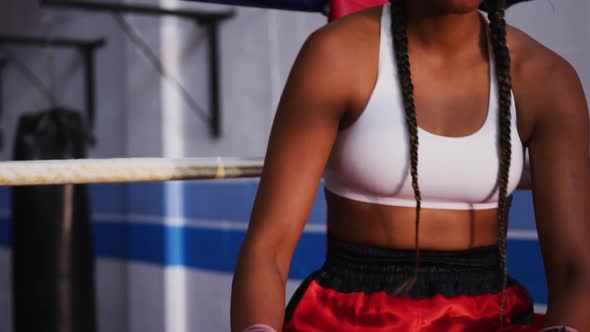 Mixed race woman in boxing ring alt
