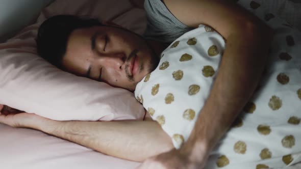 Close up of the Asian man sleeping in the bedroom at home.