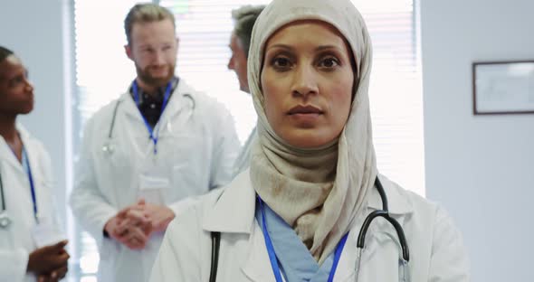 Front view of Middle-east female doctor standing with arms crossed in hospital alt