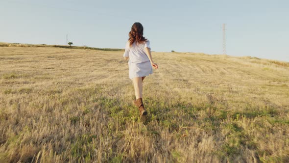 Happy Girl Running in a Field alt