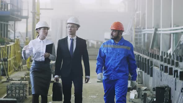 Factory team showing foreign colleague their manufacture